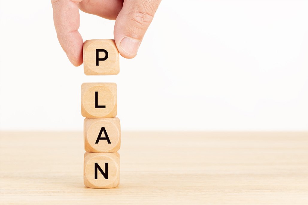 e-discovery plan concept. Hand holding wooden block with text on table.