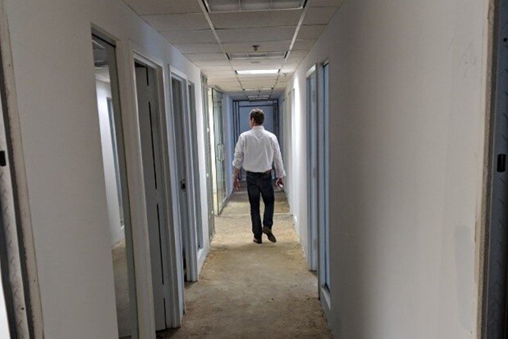 Charles Marr walking down the hallway of new Tanenholz & Associates office.
