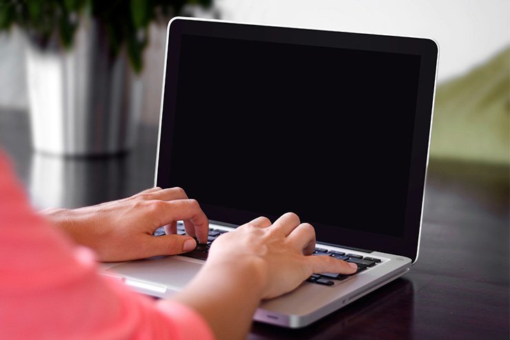 woman typing on laptop