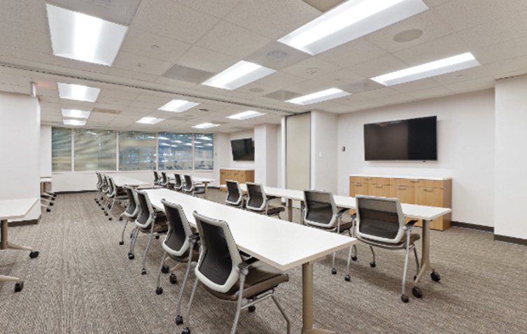 Training room with long tables and chairs.